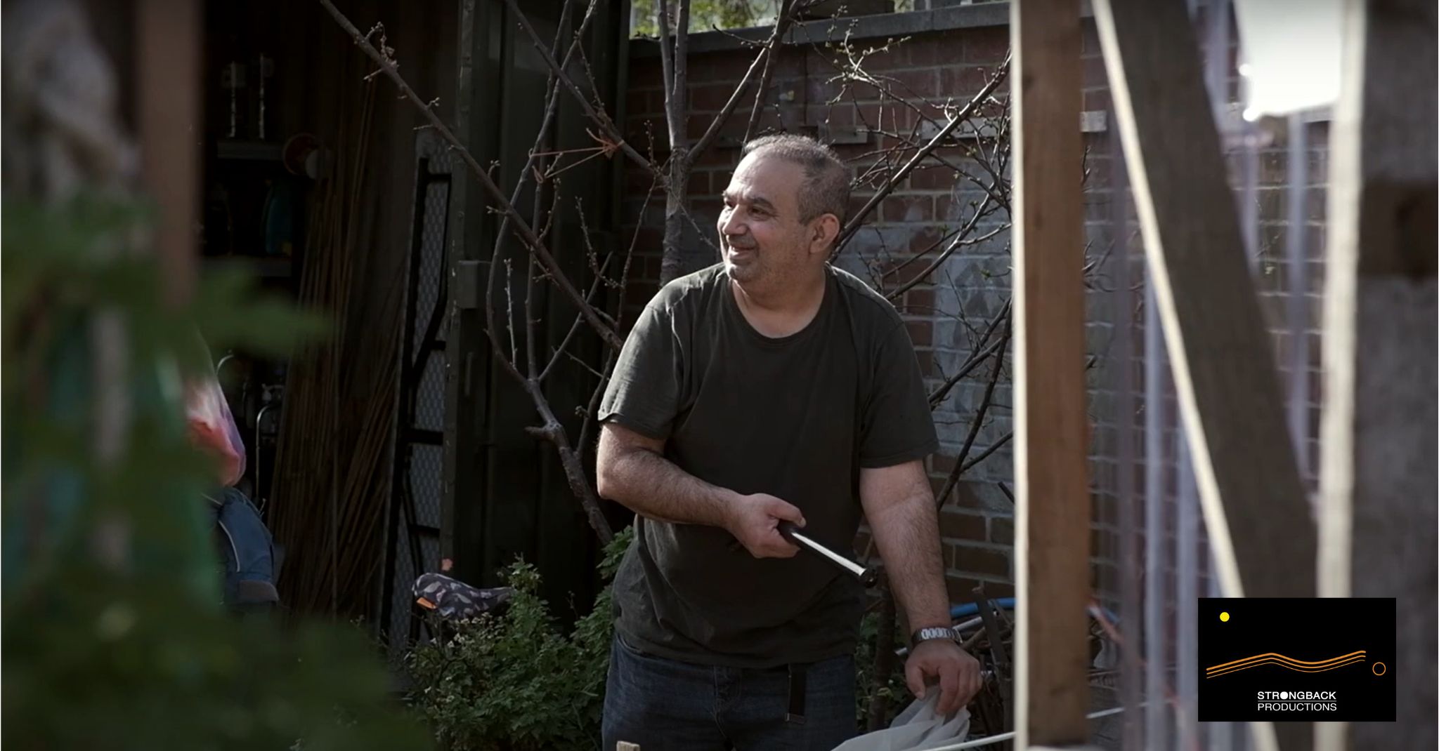 a volunteer outside pruning in Loughborough Farm